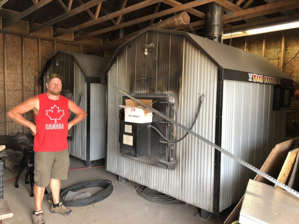 Tim Halliday with his old cordwood boilers now replaced by a Heizomat Automated Woodchip Boiler